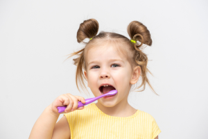 girl brushing her teeth