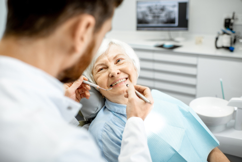 older woman getting a denture check up